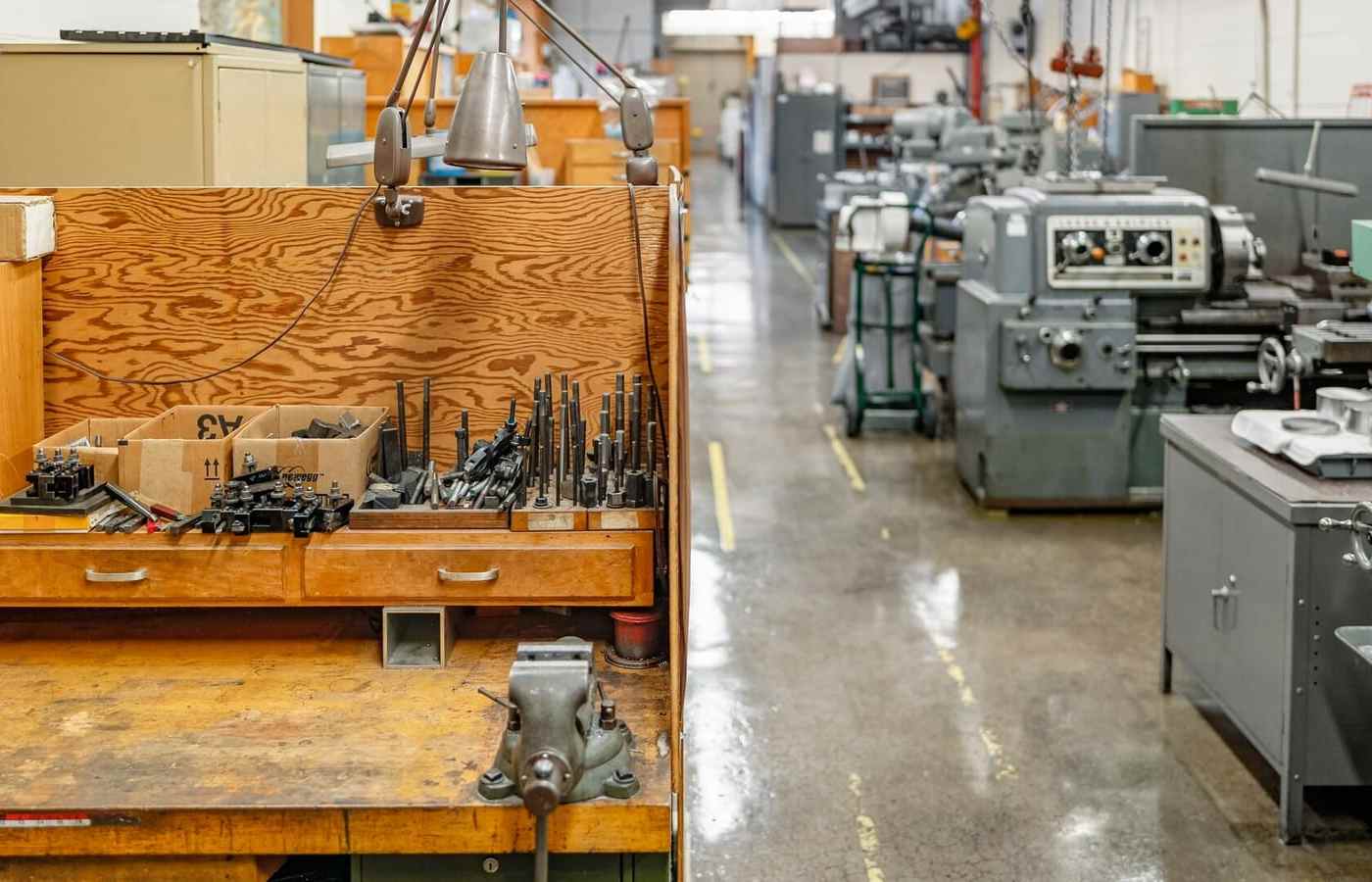 A machine shop floor with lathes, mills and a tooling bench