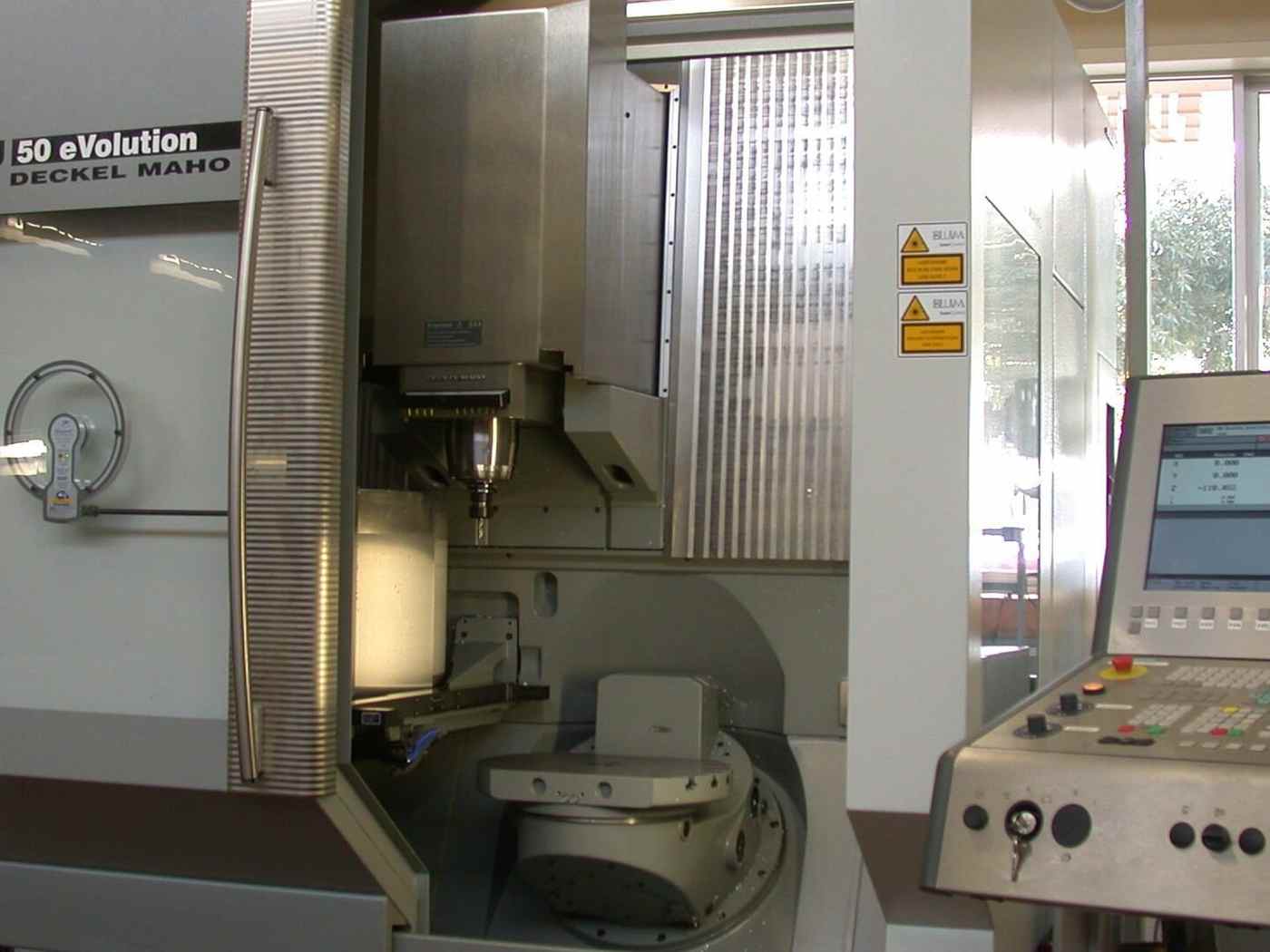 A five-axis machining centre with its control panel and enclosure